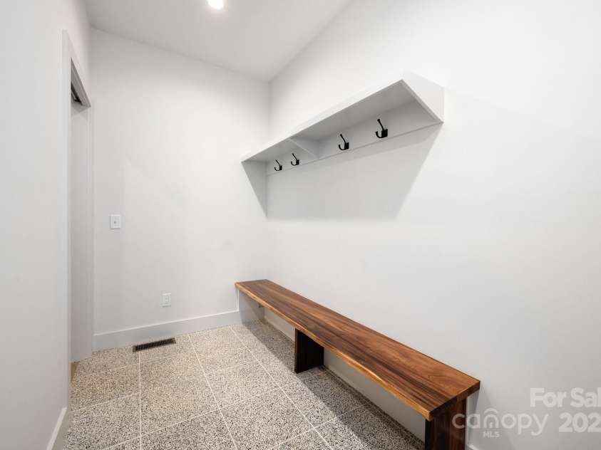 33 Windago Road, Weaverville, NC 28787.  MLS# CAR4268748, YatesRealty ID 20642. Mudroom Off of Garage with Sitting Bench and Garment Hooks