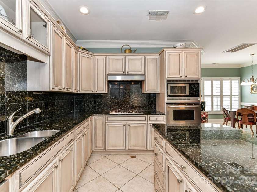 172 Harper Lee Street, Davidson, NC 28036.  MLS# CAR4249615, YatesRealty ID 20645. Pretty Kitchen with white-washed cabinets and granite countertops