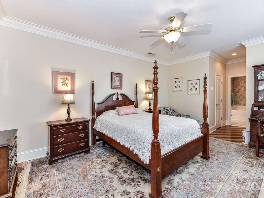172 Harper Lee Street, Davidson, NC 28036.  MLS# CAR4249615, YatesRealty ID 20645. Primary Bedroom on the main level with large windows overlooking the private courtyard