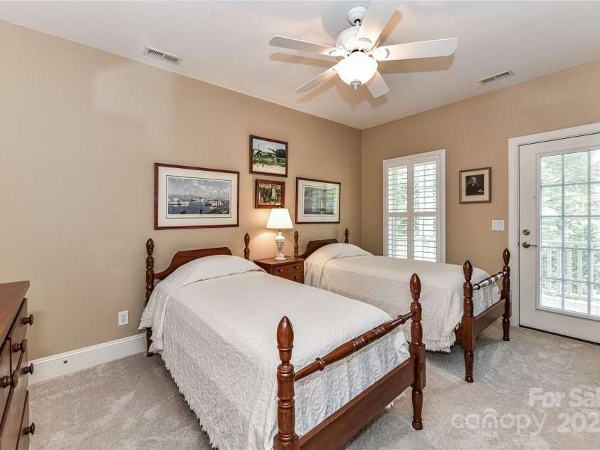 172 Harper Lee Street, Davidson, NC 28036.  MLS# CAR4249615, YatesRealty ID 20645. Spacious upstairs bedroom with access to the covered porch