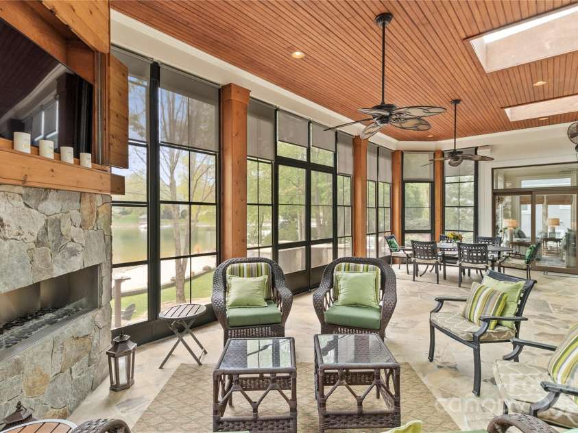 19040 Mary Ardrey Circle, Cornelius, NC 28031.  MLS# CAR4241634, YatesRealty ID 20664. Relax on the expansive screened porch, where you can watch TV and unwind by the fire, creating the ultimate outdoor living experience.