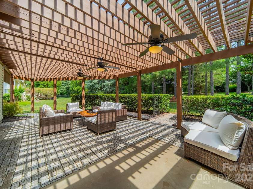 12039 Lawings Corner Drive, Huntersville, NC 28078.  MLS# CAR4256636, YatesRealty ID 20665. Back patio w/ extended pergola