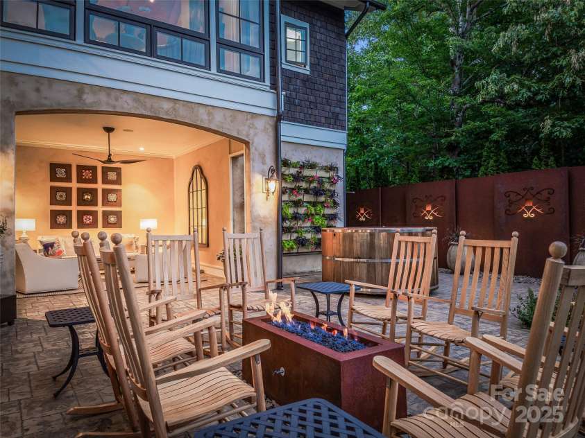 3 Bayonne Trail, Asheville, NC 28804.  MLS# CAR4262687, YatesRealty ID 20673. The open terrace provides warmth, flower wall, Main hot tub surrounded by a Corten steel are wall. 