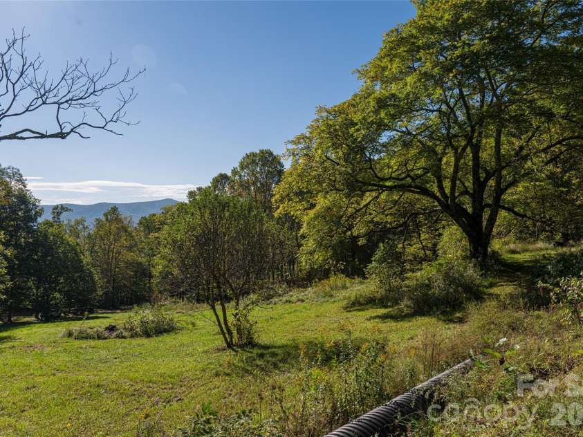 360 Banjo Branch Road, Burnsville, NC 28714.  MLS# CAR4379791, YatesRealty ID 20680. The property features multiple rolling fields perfect for additional gardens, homesteading, equestrian facilities and more. 