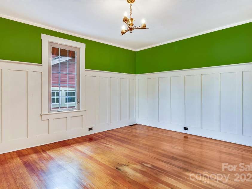 62 Elizabeth Place, Asheville, NC 28801.  MLS# CAR4254605, YatesRealty ID 20685. Spacious bedroom with original hardwood floors and stately wainscoting