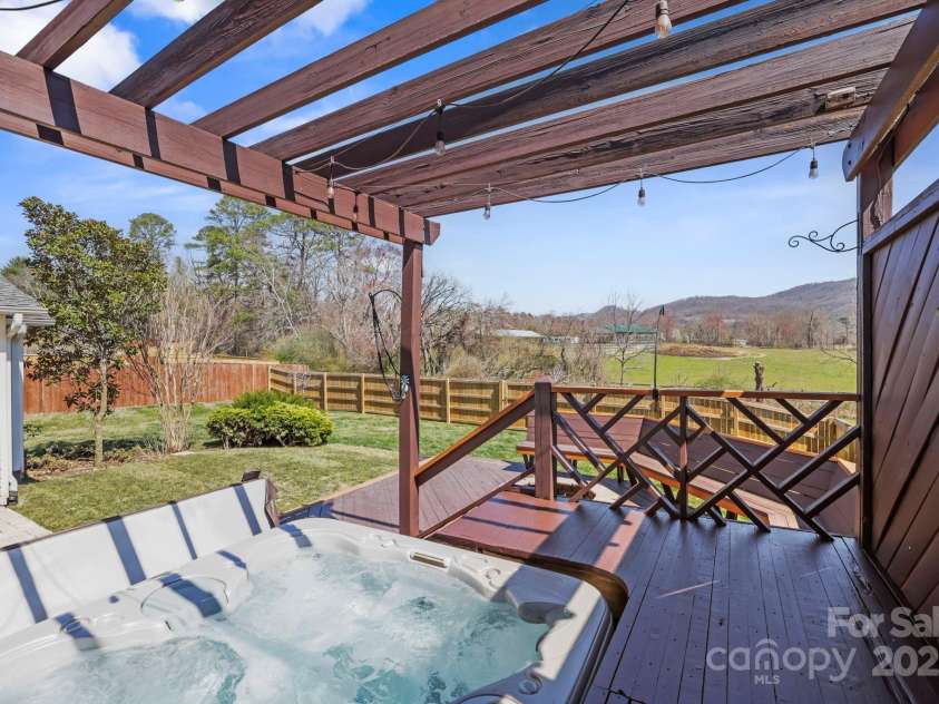 243 Wildbriar Road, Fletcher, NC 28732.  MLS# CAR4240300, YatesRealty ID 20721. Imagine soaking in this hot tub with your morning coffee while taking in the mountain and pastoral views and watching the sunrise...perfection!!