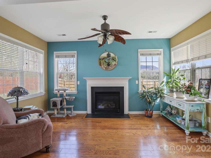243 Wildbriar Road, Fletcher, NC 28732.  MLS# CAR4240300, YatesRealty ID 20721. Sunroom complete with fireplace. Your plants will thrive in this room!