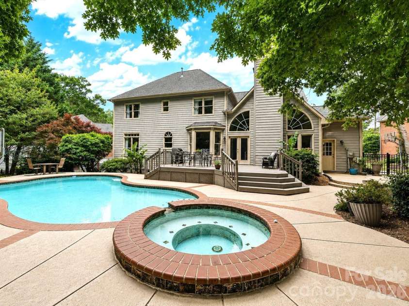 17405 Lynx Den Court, Davidson, NC 28036.  MLS# CAR4377973, YatesRealty ID 20726. Beautiful River Run home featuring a private backyard oasis with a sparkling pool, spa, and spacious deck, all surrounded by mature trees for ultimate privacy and relaxation.