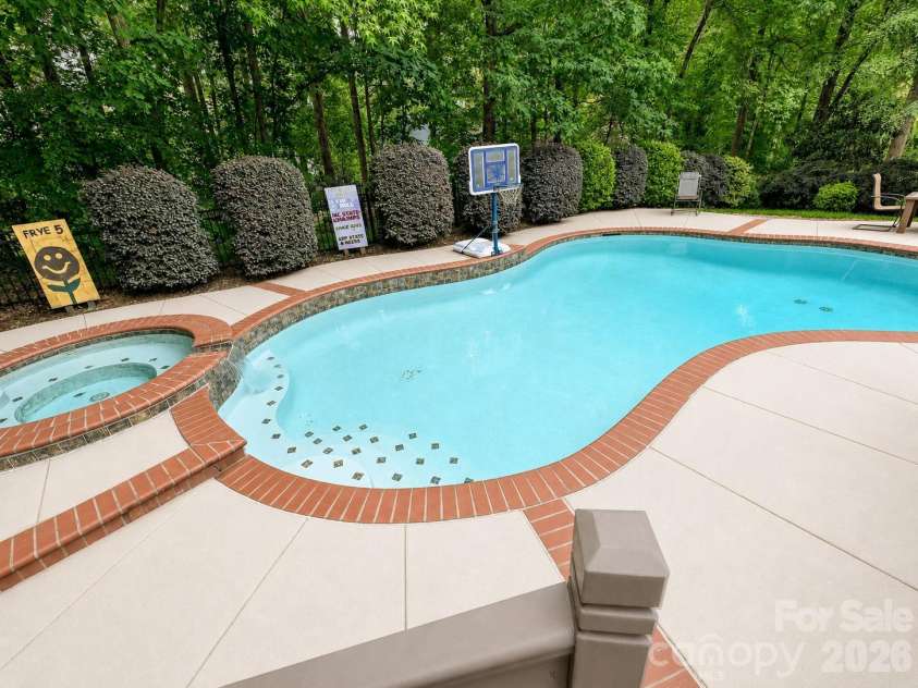 17405 Lynx Den Court, Davidson, NC 28036.  MLS# CAR4377973, YatesRealty ID 20726. Beautiful River Run home featuring a private backyard oasis with a sparkling pool, spa, and spacious deck, all surrounded by mature trees for ultimate privacy and relaxation.