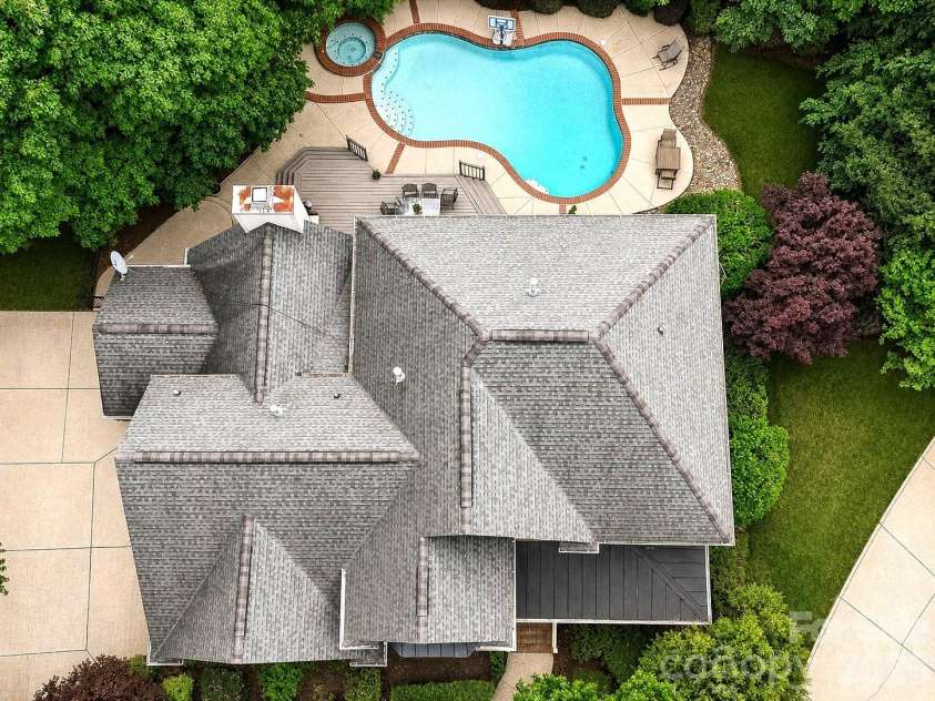 17405 Lynx Den Court, Davidson, NC 28036.  MLS# CAR4377973, YatesRealty ID 20726. Stunning River Run home tucked on a quiet cul-de-sac, featuring a private, tree-lined backyard retreat with a pool, spa, and expansive outdoor living space.