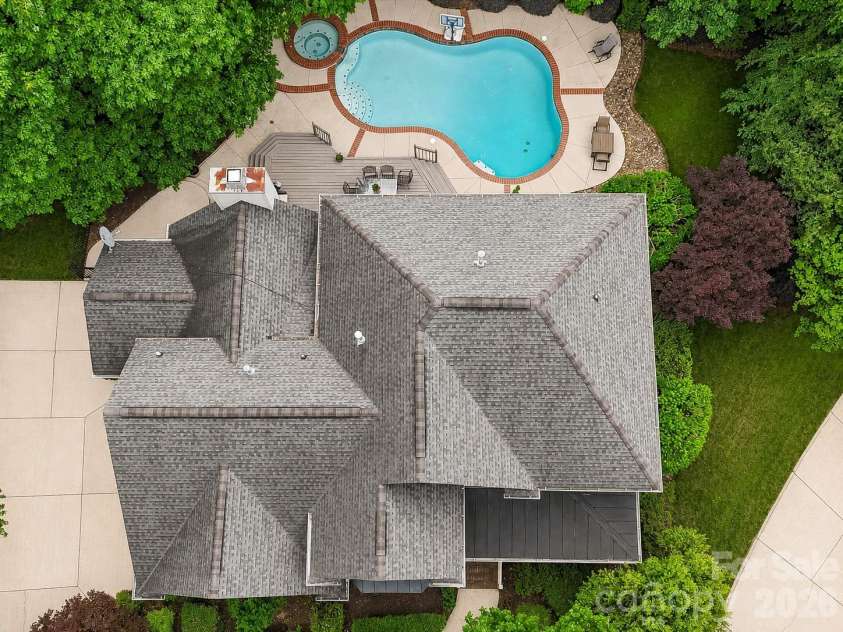 17405 Lynx Den Court, Davidson, NC 28036.  MLS# CAR4377973, YatesRealty ID 20726. Stunning River Run home tucked on a quiet cul-de-sac, featuring a private, tree-lined backyard retreat with a pool, spa, and expansive outdoor living space.