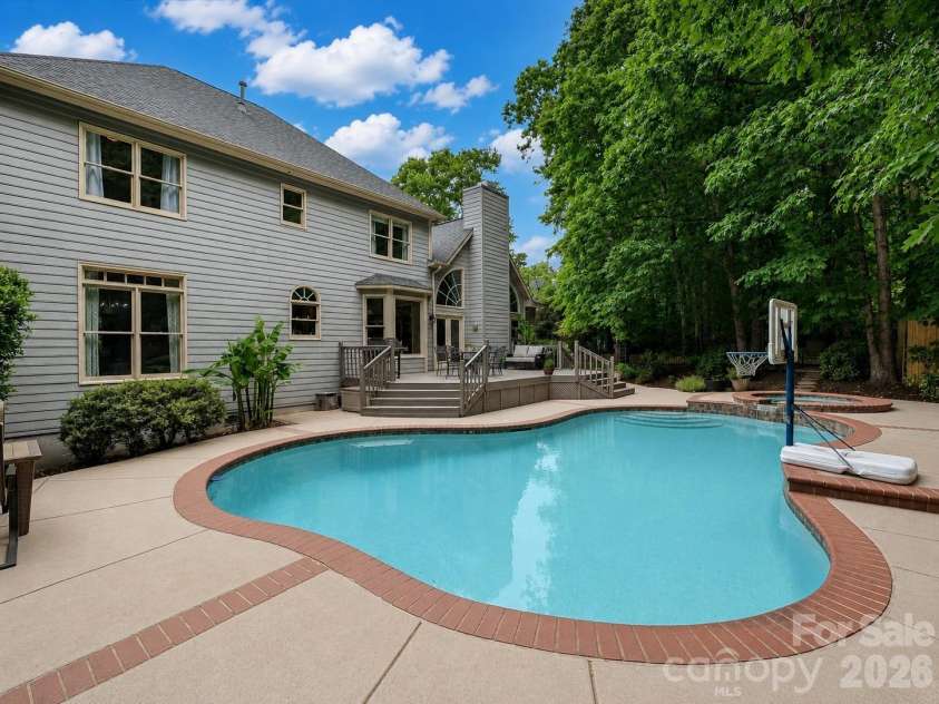 17405 Lynx Den Court, Davidson, NC 28036.  MLS# CAR4377973, YatesRealty ID 20726. Stunning River Run home tucked on a quiet cul-de-sac, featuring a private, tree-lined backyard retreat with a pool, spa, and expansive outdoor living space.
