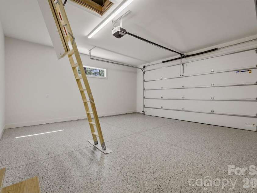 173 Waters Edge Drive, Nebo, NC 28761.  MLS# CAR4364596, YatesRealty ID 20742. Before leaving the main level, let's check out the 2 car garage. The concrete floors were coated with Torginol Epoxy Flake Garage Floor Coating which truly elevate the garage area into a showroom floor.  The transom windo