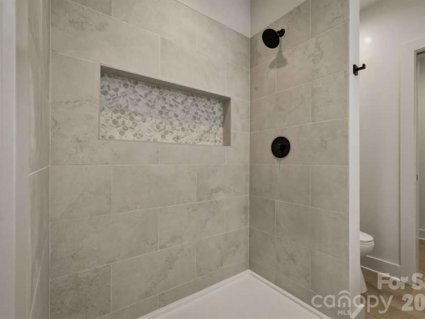173 Waters Edge Drive, Nebo, NC 28761.  MLS# CAR4364596, YatesRealty ID 20742. Here is a closer look at the walk-in shower of the fourth bathroom that has a custom shower niche.