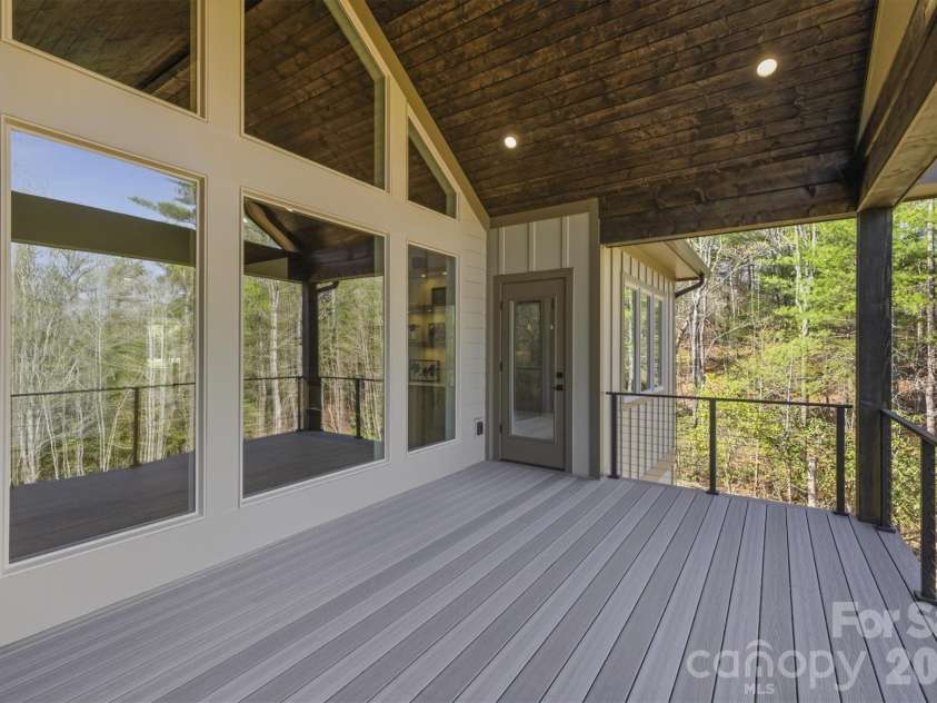 173 Waters Edge Drive, Nebo, NC 28761.  MLS# CAR4364596, YatesRealty ID 20742. Here is a different look towards the house. The door across the deck provides access to the owners' suite bedroom so we will head there next.