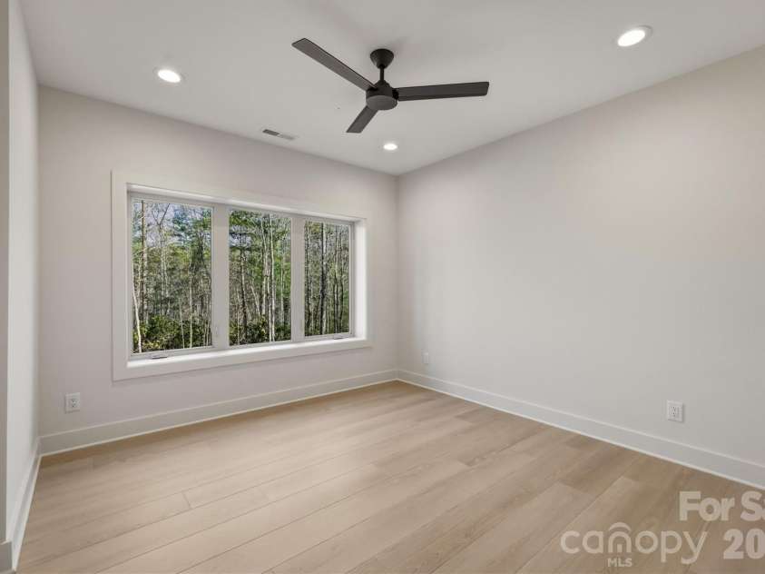 173 Waters Edge Drive, Nebo, NC 28761.  MLS# CAR4364596, YatesRealty ID 20742. Now let's see the right side of the lower level. Here is bedroom Suite #3 that also has a Minka-Aire ceiling fan, triple windows, 4 can lights....and a view, of course.
