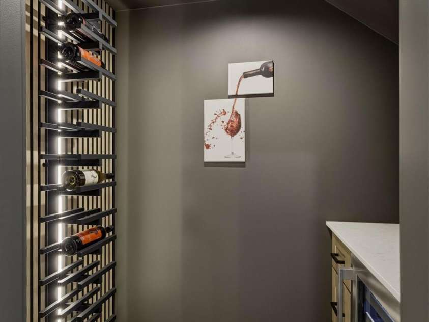 173 Waters Edge Drive, Nebo, NC 28761.  MLS# CAR4364596, YatesRealty ID 20742. One of the best hidden gems of this home is this wine cellar! No detail has been missed with the lighted wine bottle fixture, the wine refrigerator, and cabinetry. 