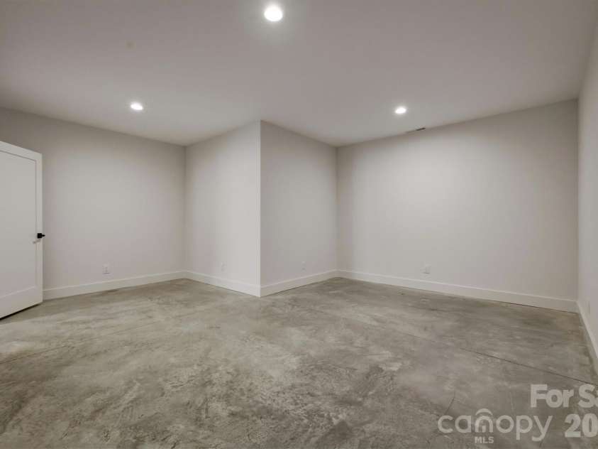 173 Waters Edge Drive, Nebo, NC 28761.  MLS# CAR4364596, YatesRealty ID 20742. The last surprise of the lower level is this 300 square foot flex space. This room would make an excellent office, home gym, hobby room, playroom, or just extra storage. This room is heated and cooled so it can be anythin