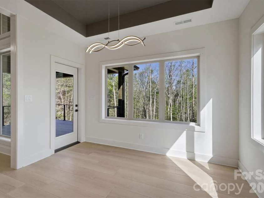 173 Waters Edge Drive, Nebo, NC 28761.  MLS# CAR4364596, YatesRealty ID 20742. We will now check out the back deck by passing through this door in the dining room.  Do not miss the dining room chandalier on the way outside.