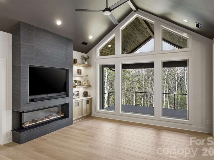 173 Waters Edge Drive, Nebo, NC 28761.  MLS# CAR4364596, YatesRealty ID 20742. When you step further in to the room, the first thing you notice is the electric linear fireplace. Hanging over that is a 65