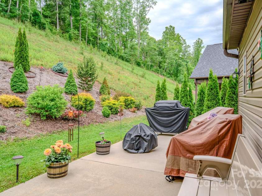 153 Water Leaf Drive, Weaverville, NC 28787.  MLS# CAR4260555, YatesRealty ID 20771. Double Patio and Lush Plantings