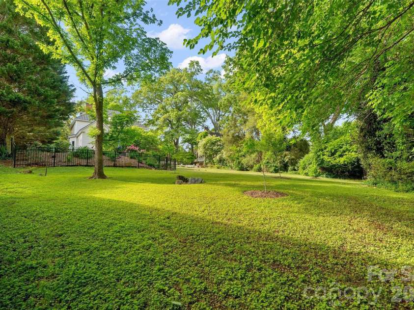 602 Main Street, Davidson, NC 28036.  MLS# CAR4376651, YatesRealty ID 20788. Private Level Backyard with Fenced in-ground pool