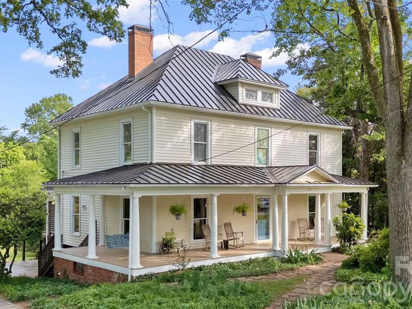 602 Main Street, Davidson, NC 28036.  MLS# CAR4376651, YatesRealty ID 20788. Timeless two-story Colonial Revival featuring a wraparound porch with classical columns and a pedimented entry. Ideally located just steps from Davidson College and all that downtown Davidson has to offer.