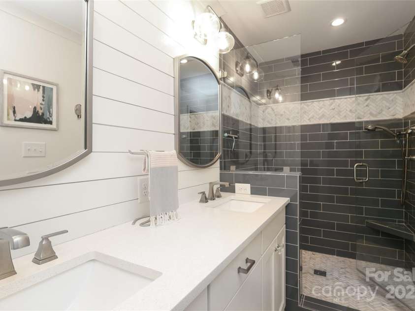 4126 Tyndale Avenue, Charlotte, NC 28210.  MLS# CAR4268563, YatesRealty ID 20792. Primary bath with shiplap, custom dual vanity, modern lighting and classic finishes