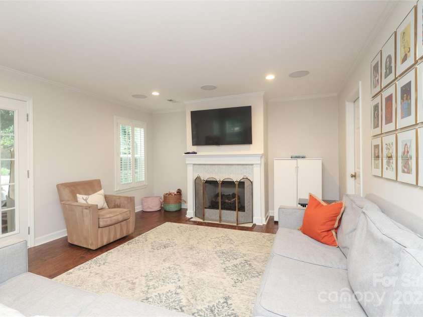 4126 Tyndale Avenue, Charlotte, NC 28210.  MLS# CAR4268563, YatesRealty ID 20792. Second living space/ family room with gas fireplace and access to a screened porch