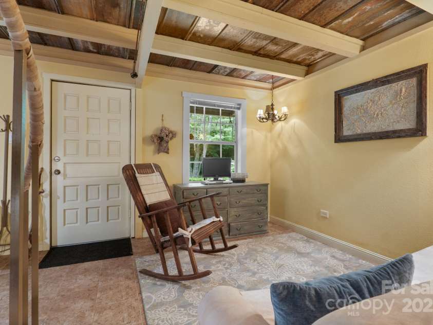 80 Laurel Canyon Road, Franklin, NC 28734.  MLS# CAR4270579, YatesRealty ID 20799. Lower-Level Rec Room with Bunk Area & Fireplace