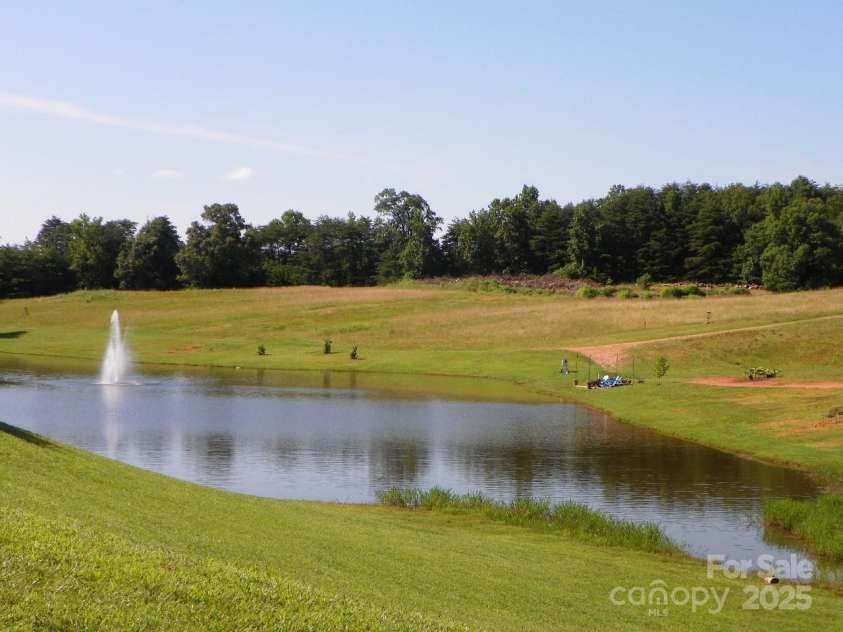 166 Eagle Drive, New London, NC 28127.  MLS# CAR4271205, YatesRealty ID 20800. Fishing pond as you enter BSR ( catch and release)