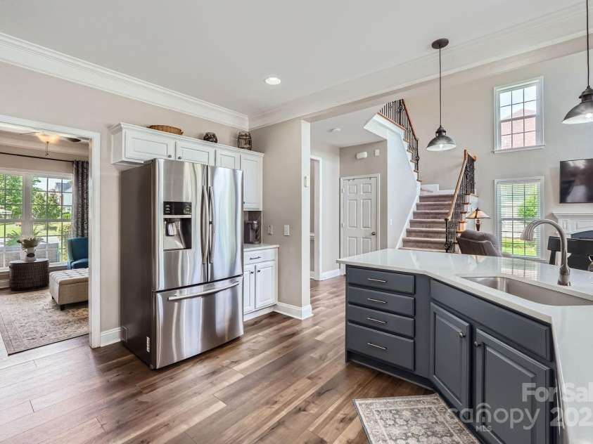 113 Dairy Farm Road, Mooresville, NC 28115.  MLS# CAR4262731, YatesRealty ID 20820. Modern pendant lights create a warm ambiance over the island, while stainless steel appliances and a deep undermount sink add everyday convenience.
