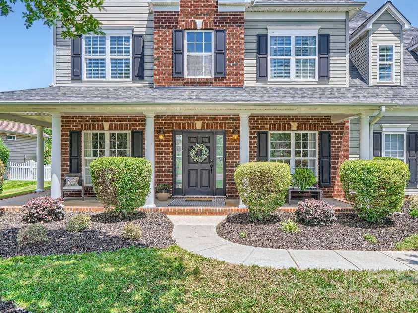 113 Dairy Farm Road, Mooresville, NC 28115.  MLS# CAR4262731, YatesRealty ID 20820. The covered front porch offers the perfect spot to relax in the shade and greet guests, while the classic black front door with a seasonal wreath sets a warm, stylish tone.