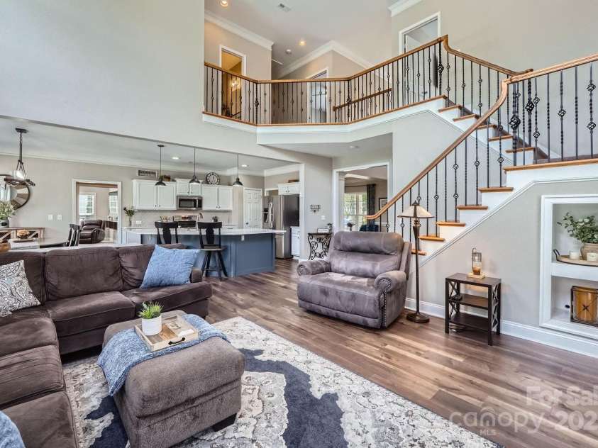 113 Dairy Farm Road, Mooresville, NC 28115.  MLS# CAR4262731, YatesRealty ID 20820. The open-concept design effortlessly connects the living area to the kitchen and dining spaces, creating a seamless flow perfect for both relaxing and entertaining.