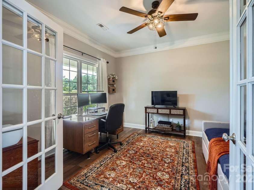 113 Dairy Farm Road, Mooresville, NC 28115.  MLS# CAR4262731, YatesRealty ID 20820. This bright and functional home office is the perfect blend of productivity and comfort. French doors add a touch of elegance and privacy, while large windows allow for plenty of natural light and calming views of th