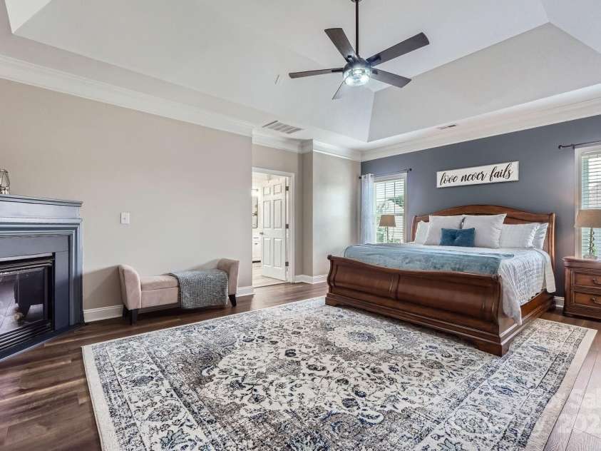 113 Dairy Farm Road, Mooresville, NC 28115.  MLS# CAR4262731, YatesRealty ID 20820. This serene primary bedroom blends comfort and elegance with its tray ceiling, crown molding, and soothing color palette.