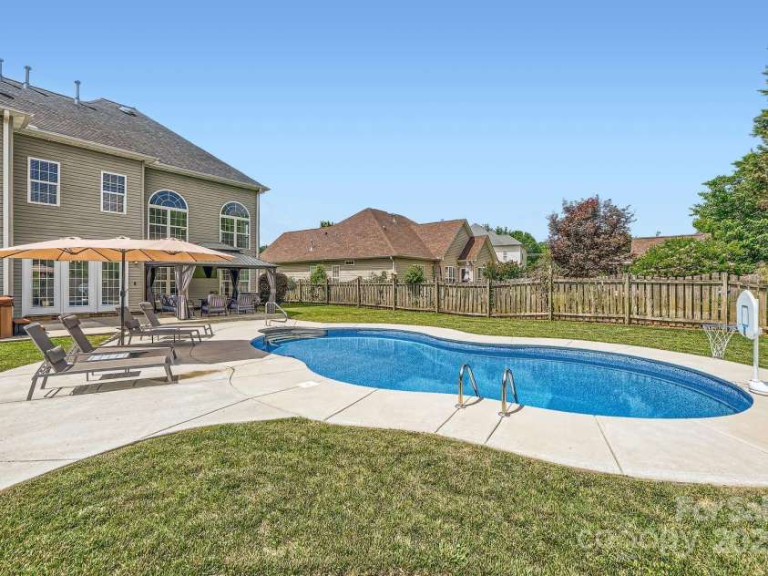 113 Dairy Farm Road, Mooresville, NC 28115.  MLS# CAR4262731, YatesRealty ID 20820. Whether you're hosting a summer pool party or enjoying a quiet morning swim, this space was designed for comfort and recreation. The fenced yard provides privacy and peace of mind. A true retreat just steps from your