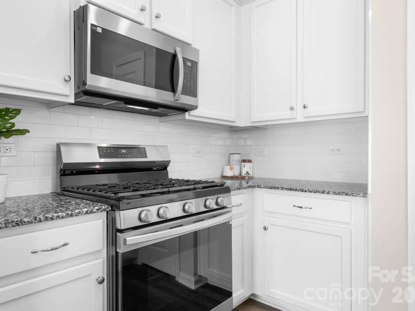 3939 Townes Boulevard, Terrell, NC 28682.  MLS# CAR4380268, YatesRealty ID 20824. Gas range, granite countertops and white cabinetry
