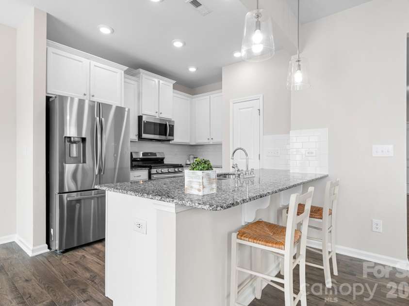 3939 Townes Boulevard, Terrell, NC 28682.  MLS# CAR4380268, YatesRealty ID 20824. Upgraded kitchen pendent lighting, granite countertops, subway tile backsplash, stainless appliances