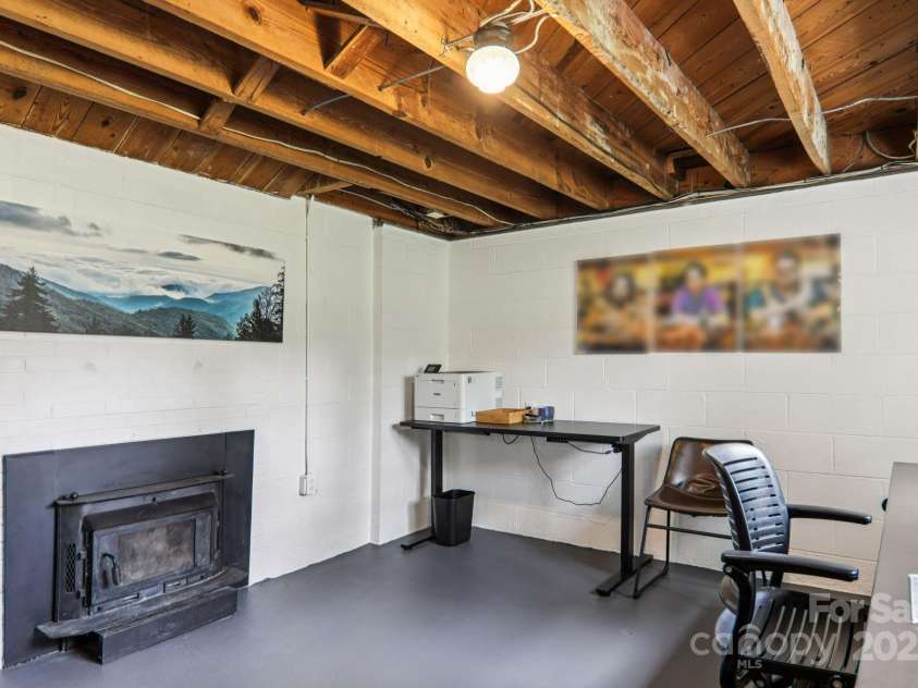 318 Old Leicester Highway, Asheville, NC 28806.  MLS# CAR4261061, YatesRealty ID 20828. Partially Finished Basement w Fireplace