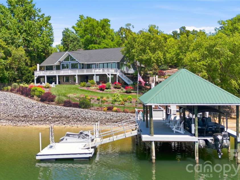 17812 Wilbanks Drive, Charlotte, NC 28278.  MLS# CAR4373319, YatesRealty ID 20830. The private covered dock with lift and floating dock offers direct access to Lake Wylie for boating and recreation