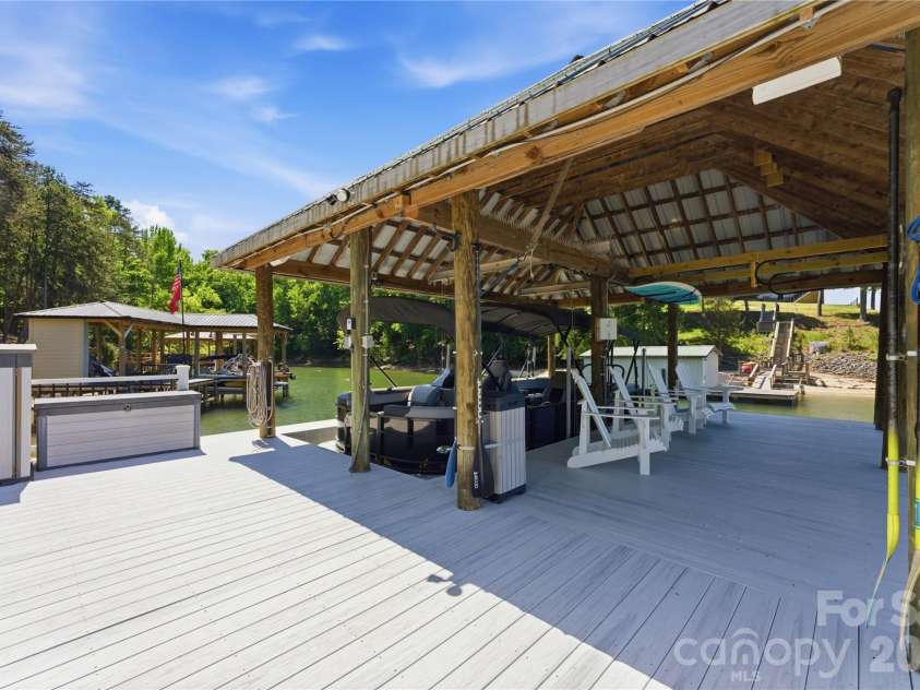 17812 Wilbanks Drive, Charlotte, NC 28278.  MLS# CAR4373319, YatesRealty ID 20830. The private covered dock with lift and floating dock offers direct access to Lake Wylie for boating and recreation