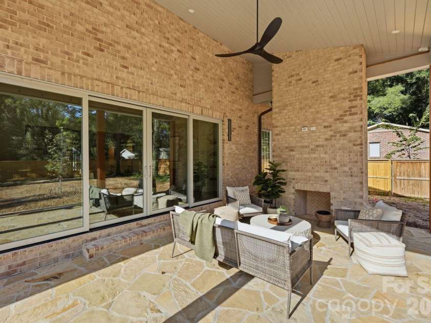 110 Hunter Lane, Charlotte, NC 28211.  MLS# CAR4424085, YatesRealty ID 20843. Covered Lanai - Wood Burning Firepalce - Stone Floor - Ceiling Fan