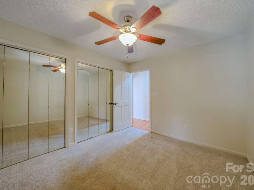 4 Hedgerose Court, Asheville, NC 28805.  MLS# CAR4356558, YatesRealty ID 20859. Bedroom 1 with ample closet space and a ceiling fan