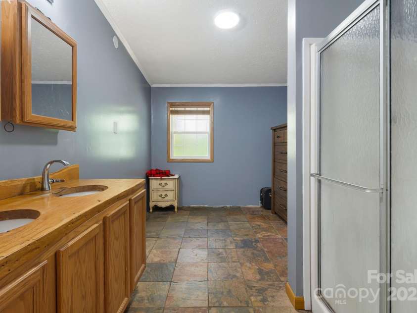 35 Evelyn Acres Drive, Asheville, NC 28806.  MLS# CAR4312401, YatesRealty ID 20886. Spacious primary bathroom with handmade double vanity.