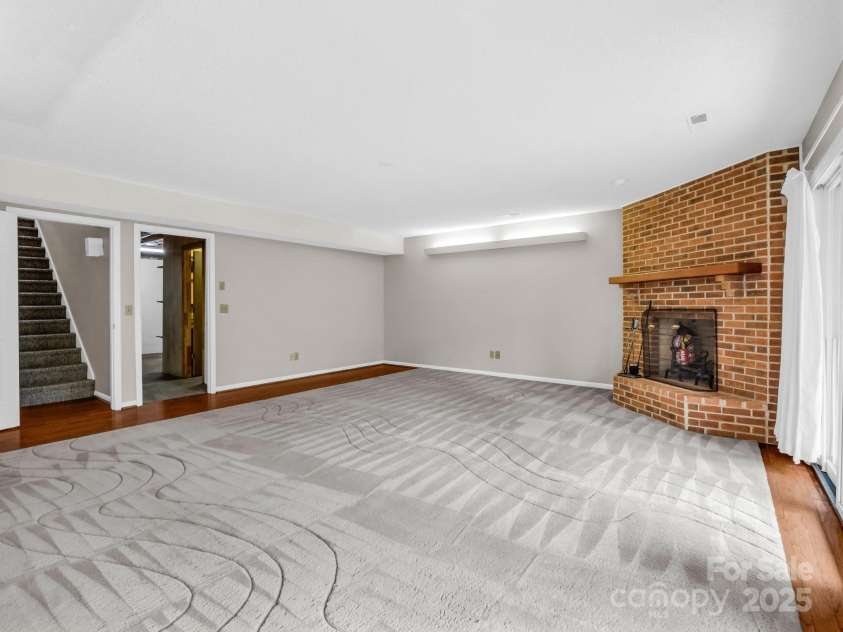 31 Hunting Country Trail, Tryon, NC 28782.  MLS# CAR4240091, YatesRealty ID 20903. Den with wood fireplace in basement