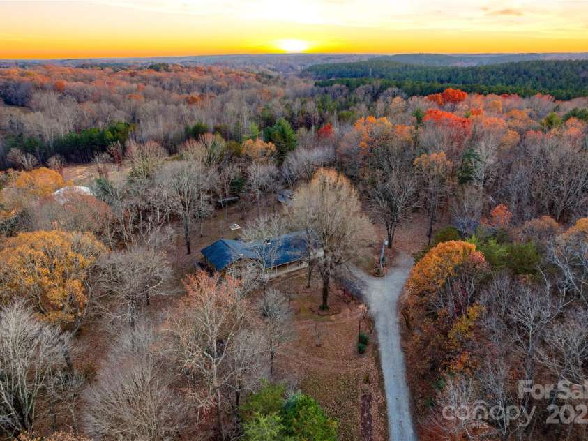 2619 Hopewell Church Road, Sherrills Ford, NC 28673.  MLS# CAR4265772, YatesRealty ID 2091. Enjoy 5+ acres of privacy, tall hardwoods, and established muscadine vines with plenty of garden space.
