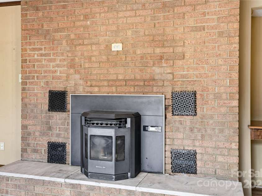2619 Hopewell Church Road, Sherrills Ford, NC 28673.  MLS# CAR4265772, YatesRealty ID 2091. Pellet stove warms this living area with efficiency and charm.