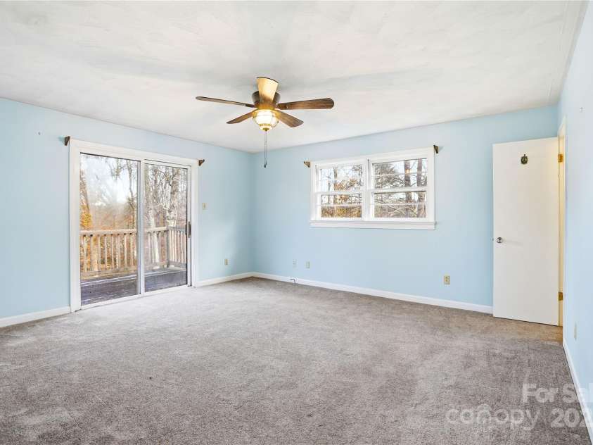 2619 Hopewell Church Road, Sherrills Ford, NC 28673.  MLS# CAR4265772, YatesRealty ID 2091. Primary bedroom with private deck access, offering peaceful views and a serene retreat.