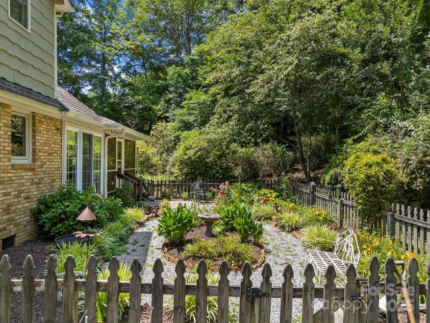 266 Case Street, Columbus, NC 28722.  MLS# CAR4265986, YatesRealty ID 20911. Fenced in patio for pets with easy care shrubs.